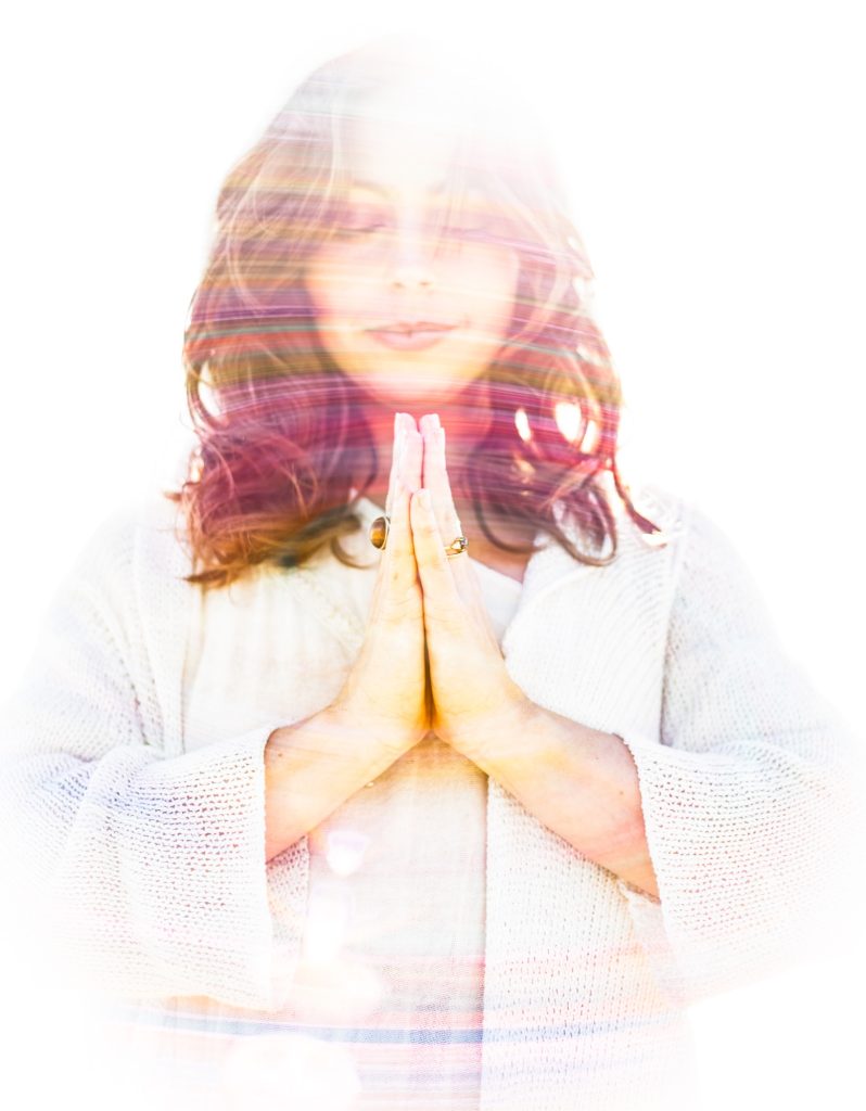 Jaime Elkayam with hands in prayer, light double exposure