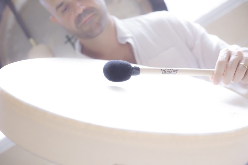 Yonatan Elkayam playing a frame drum in soft light at Word of Mouth, Los Angeles